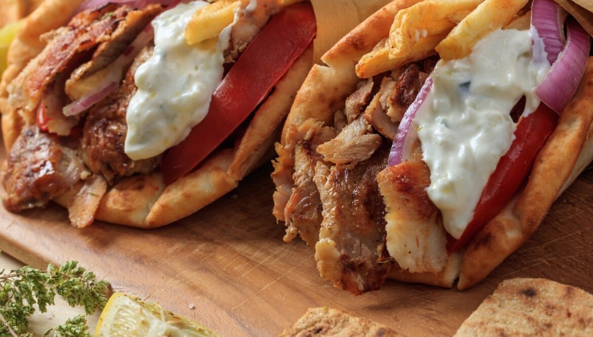 Gyros grilled meat slices in a pita bread closeup view Athens Food Steps Athens Food Steps Gyros grilled meat slices in a pita bread closeup view