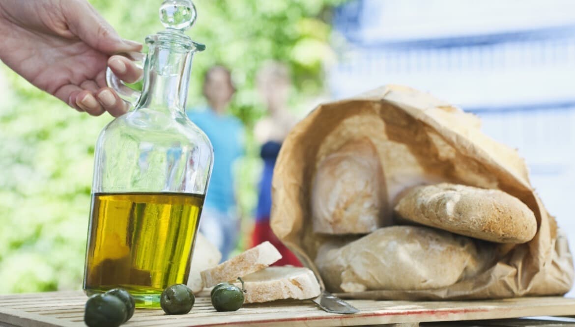 Italy Tuscany Magliano Close up of bread olive oil and olives on wooden table Athens Food Steps Athens Food Steps Italy Tuscany Magliano Close up of bread olive oil and olives on wooden table