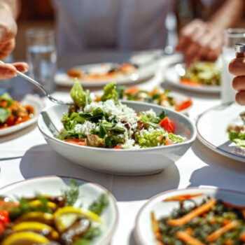 Couple Eating Lunch with Fresh Salad and Appetizers #post_title #site_title